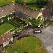 Cotswold Farmhouse with period barns and open courtyard.